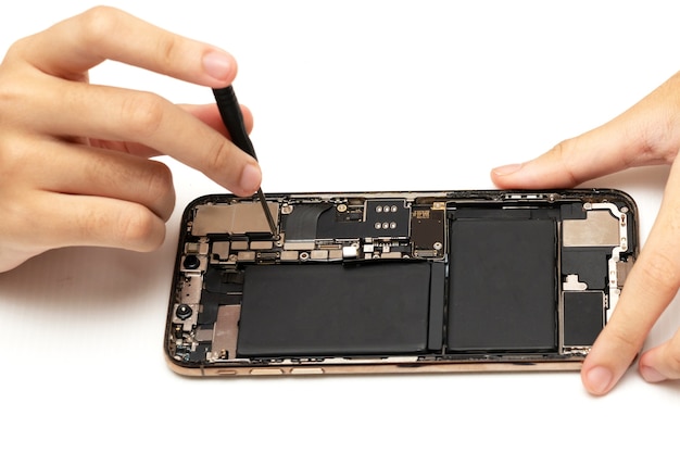 technician replaces the battery of a cell phone or smartphone