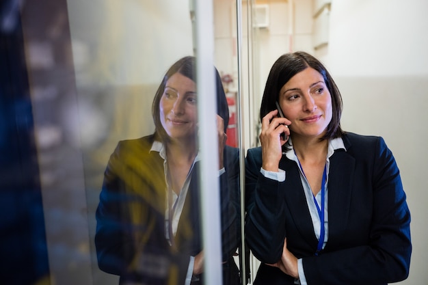 Technician talking on mobile phone