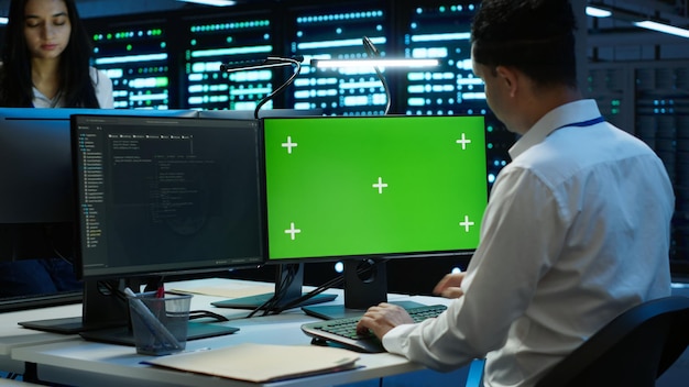 Photo technician using mockup computer in data center