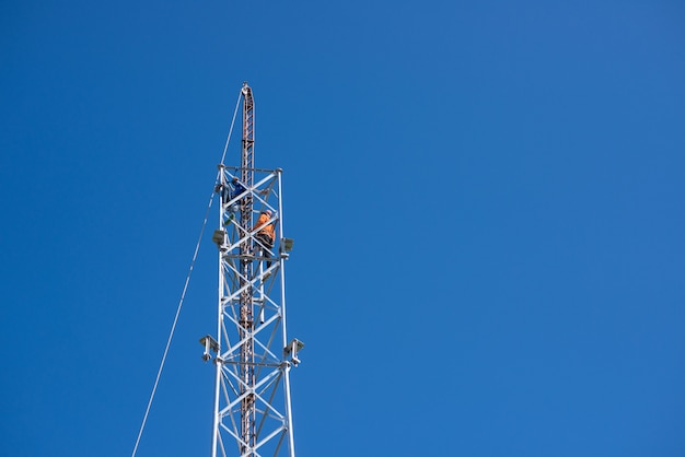 Technician work on a telecommunication tower, The smith worked on a telephone pole