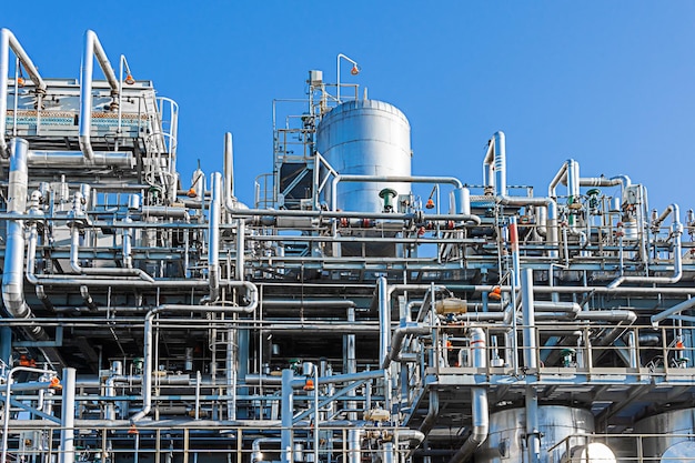 Technological equipment of a part of a gas processing plant on a blue sky background