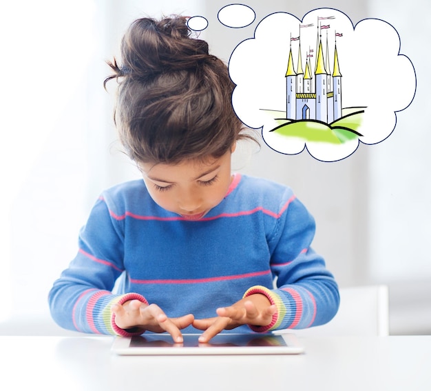 technology, childhood, entertainment and imagination concept - little girl playing with tablet pc computer and thinking about fairytale castle at home