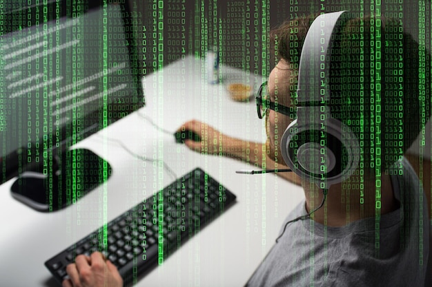 technology, gaming, entertainment, let&amp;#39;s play and people concept - close up of young man in headset and glasses with pc computer playing game at home and streaming playthrough or walkthrough v