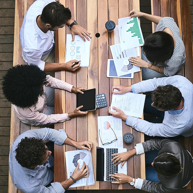 Technology helps them succeed High angle shot of a team of businesspeople having a meeting outside