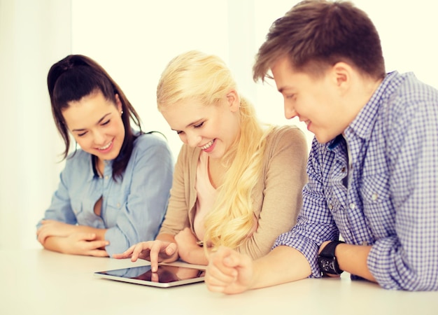 technology, internet, school and education concept - group of smiling teenage students with tablet pc computer at school