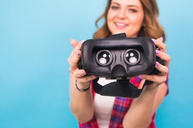 Technology, virtual reality, entertainment and people concept - Girl give virtual reality goggles.