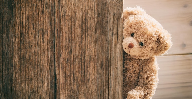 Teddy bear on wooden background