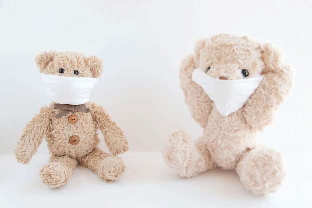 Teddy bears wear a sanitary mask to protect coronavirus and flu outbreak. Virus and illness protection.