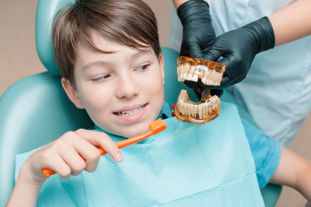 Teen boy having dental treatment at dentists office Healthy teeth dental care concept