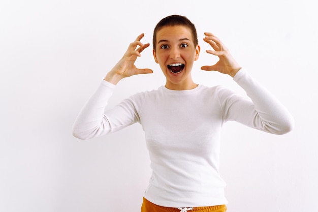 Teen girl, empty place for text or logo on apparel, short brown hair, shows emotion of anger horror