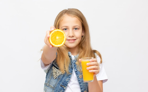 Teen girl holding glass of orange juice on white background