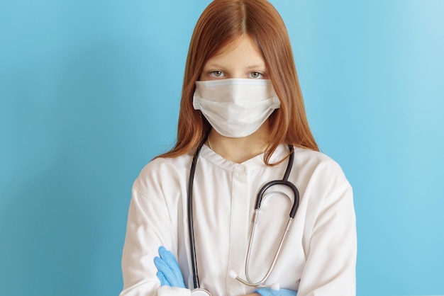 teen girl plays doctor concept of choosing profession for child in face mask and with phonendoscope