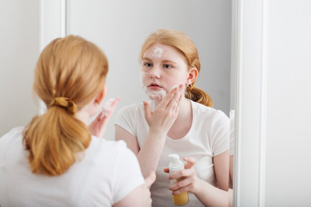 Teen girl puts on face mask