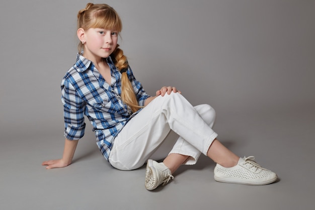 Teen girl sitting on floor and dreaming, long hair