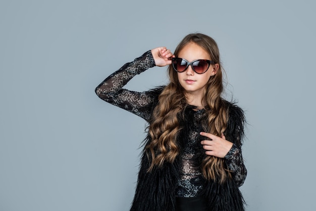 Teen girl with long curly hair wear trendy sunglasses fashion