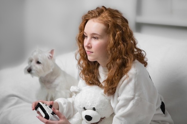 Teen girl with red hair, Generation Z, playing a video game