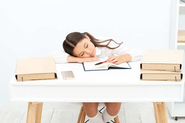 Teen school girl sleeping at the desk photo of teen school girl sleeping