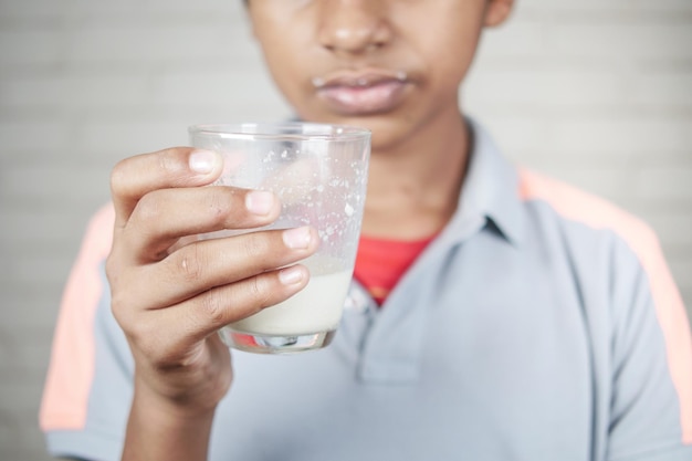 Teenage boy drinking glass of milk