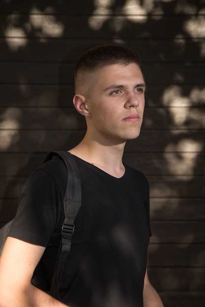 Teenage Boy looking at camera on background of Urban wall