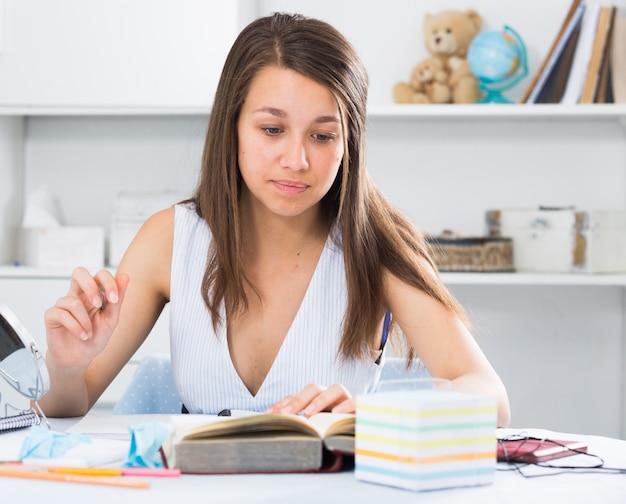 Teenage female is preparing herself for exams