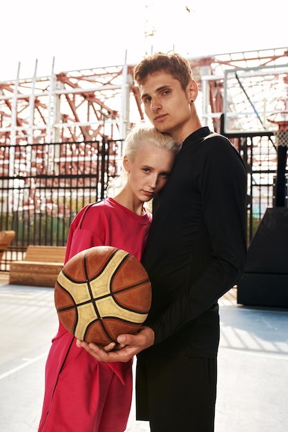 Teenage friends enjoying a game of streetball on outdoor court