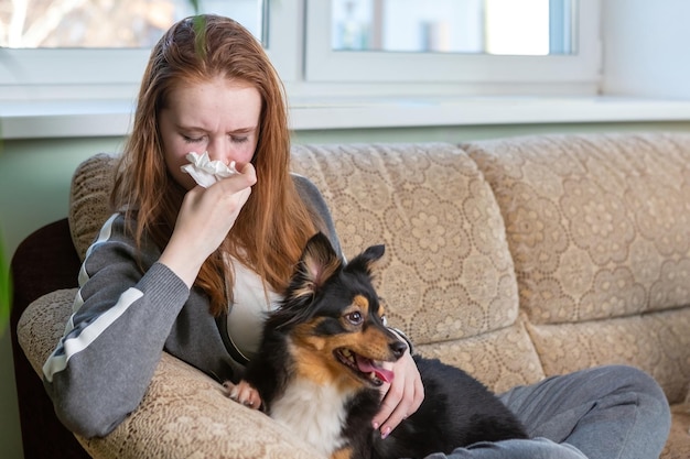 Teenage girl crying at home hugging a dog depression after breaking up with a guy