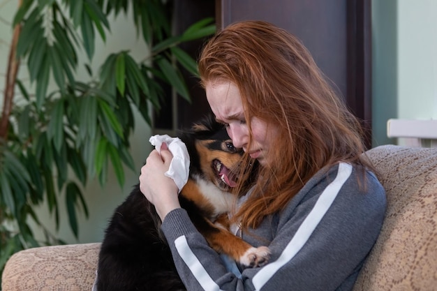 Teenage girl crying at home hugging a dog depression after breaking up with a guy