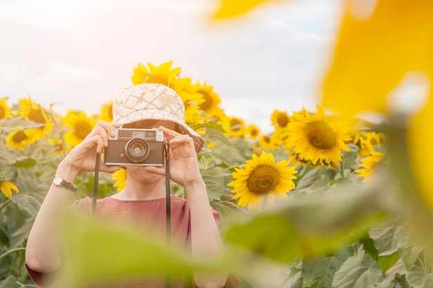 Teenage girl holding film camera 