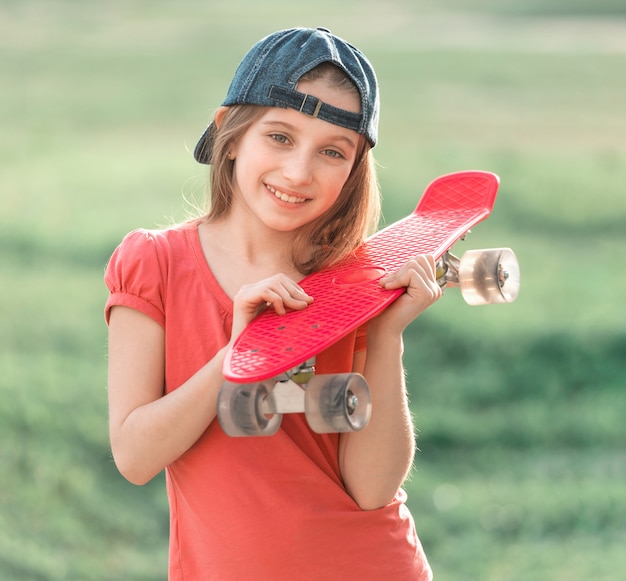 Teenage girl holding her pink board