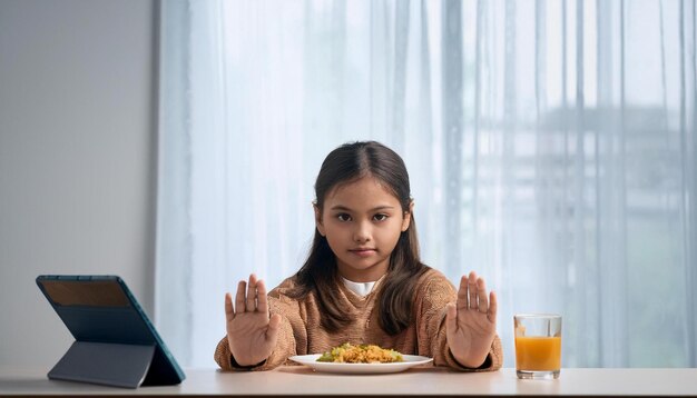 Photo a teenage girl pushing away a plate of food at the dining table