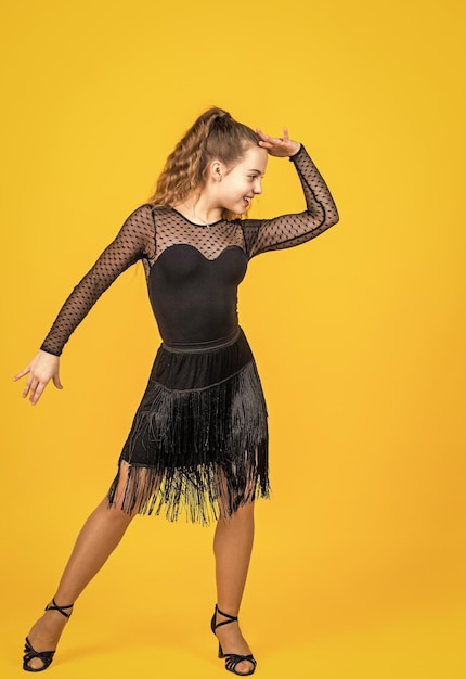 Teenage girl straight ballroom dancer wear black dress in dance pose dance