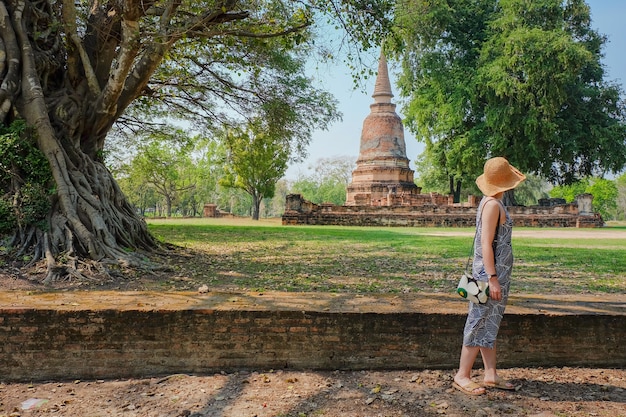 Teenage girl traveling old temple ,Thailand in people with landscape concept.