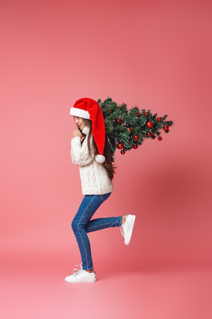 Teenage girl with a Christmas tree