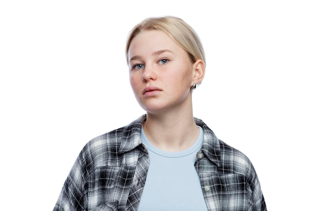 Teenage girl with a dissatisfied face Cute blonde girl looking down Depression and aggression Isolated on a white background