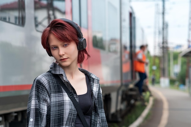 Teenage girl with headphones at commuter train station