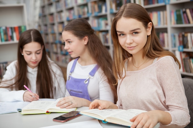 Teenage girls studying together at the library