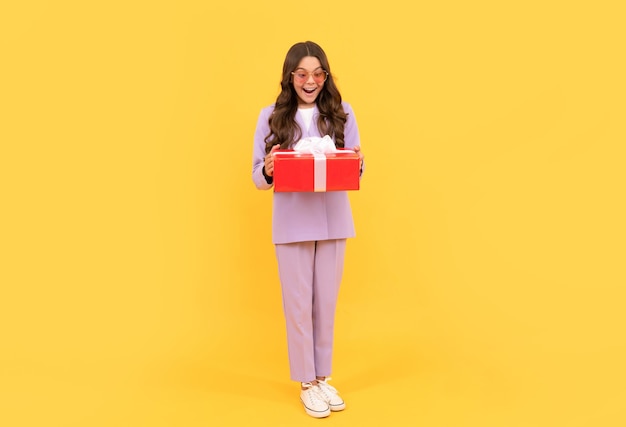 teenage shopper. stylish teen girl in jacket and eyeglasses hold gift box. shopping time. amazed kid hold present. child prepare for holiday. happy valentines day. shopping final sell out.