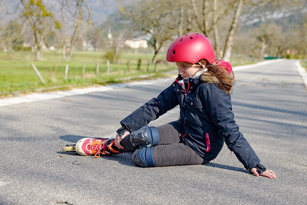 Teenage skater grimacing in pain after taking fall