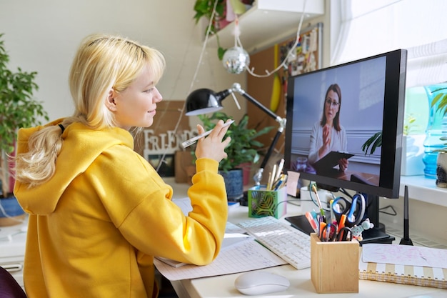 Teenage student having an online lesson on the computer at home