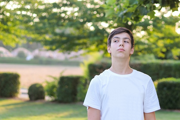 Teenager boy in white shirt looking arrogantly and  offended at someone. Vulnerability of 