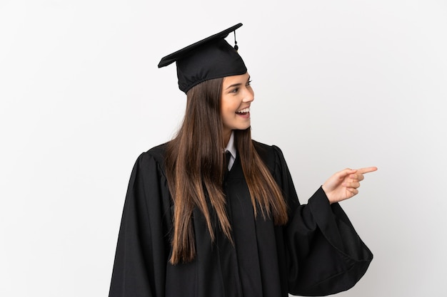 Teenager Brazilian university graduate over isolated white background pointing finger to the side and presenting a product