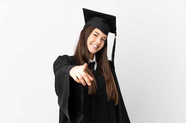 Teenager Brazilian university graduate over isolated white background pointing front with happy expression