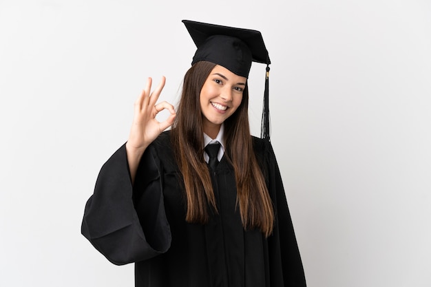 Teenager Brazilian university graduate over isolated white background showing ok sign with fingers