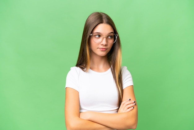 Teenager caucasian girl over isolated background keeping the arms crossed