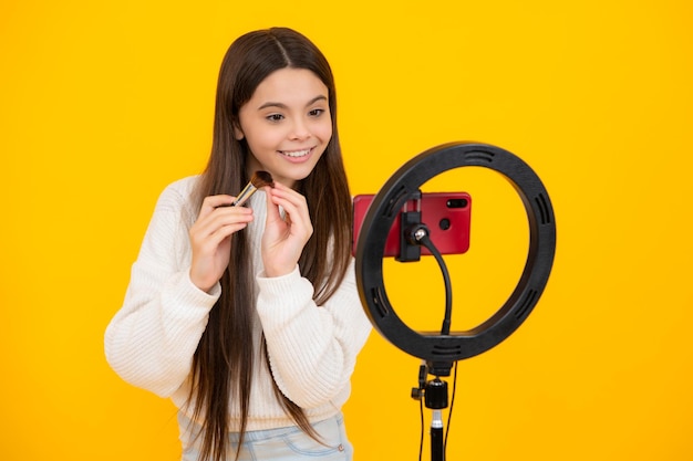 Teenager child recording video tutorial for social media with smart phone Beauty blog presenting