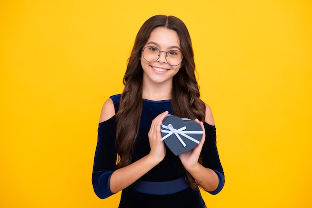 Teenager child with gift box Present for holidays Happy birthday Valentines day New Year or Christmas Kid hold present box Happy face positive and smiling emotions of teenager girl