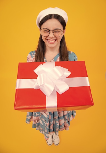 Teenager child with gift box Present for holidays Happy birthday Valentines day New Year or Christmas Kid hold present box Happy teenager positive and smiling emotions