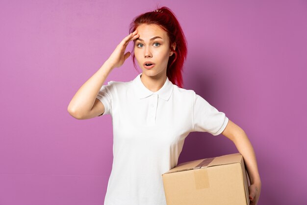 Teenager delivery girl isolated on purple background has realized something and intending the solution