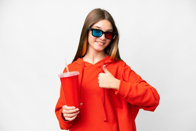 Teenager girl in a cinema over isolated white background giving a thumbs up gesture