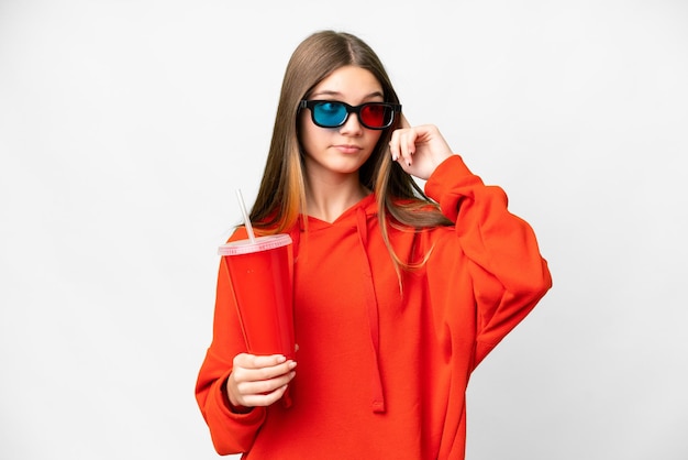 Teenager girl in a cinema over isolated white background having doubts and thinking